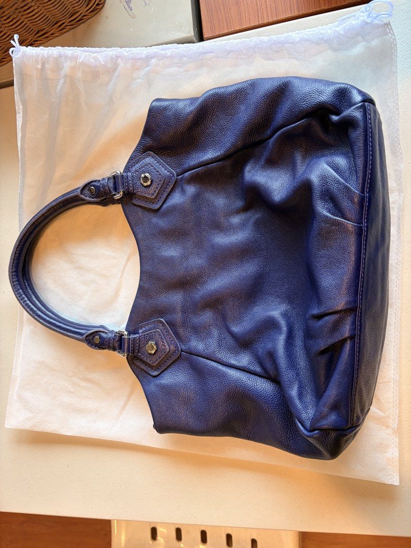 Marc by Marc Jacobs Blue Leather Shoulder Bag (Category: Luxury Bags & Wallets) located in Quezon City. Submitted by iellahs (Listing ID 1465386859, Image 2). Description: - Authentic Marc by Marc Jacobs shoulder bag in a rich blue pebbled leather - Silver-tone hardware and chic buckle strap details - Secure top zip and magnetic snap closure - Iconic black and white logo printed fabric interior lining - Practical internal zip pocket and slip comp
