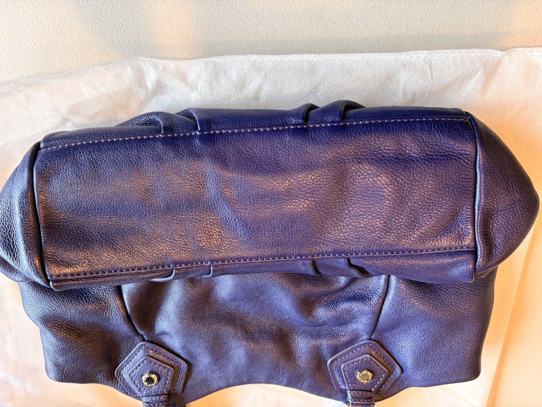 Marc by Marc Jacobs Blue Leather Shoulder Bag (Category: Luxury Bags & Wallets) located in Quezon City. Submitted by iellahs (Listing ID 1465386859, Image 3). Description: - Authentic Marc by Marc Jacobs shoulder bag in a rich blue pebbled leather - Silver-tone hardware and chic buckle strap details - Secure top zip and magnetic snap closure - Iconic black and white logo printed fabric interior lining - Practical internal zip pocket and slip comp
