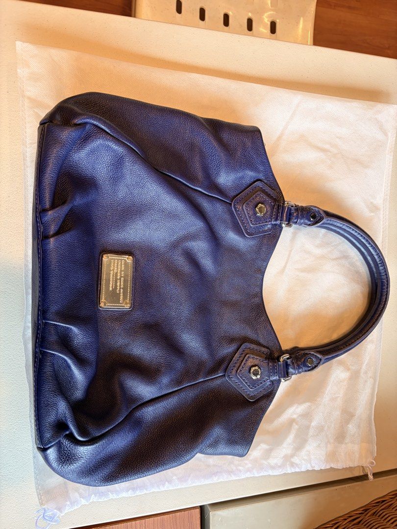 Marc by Marc Jacobs Blue Leather Shoulder Bag (Category: Luxury Bags & Wallets) located in Quezon City. Submitted by iellahs (Listing ID 1465386859, Image 1). Description: - Authentic Marc by Marc Jacobs shoulder bag in a rich blue pebbled leather - Silver-tone hardware and chic buckle strap details - Secure top zip and magnetic snap closure - Iconic black and white logo printed fabric interior lining - Practical internal zip pocket and slip comp