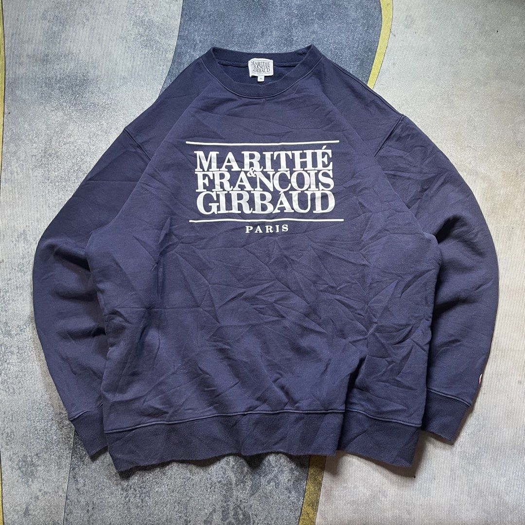 Marithe Francois Girbaud Classic Logo Navy Blue Sweatshirt XL (Category: Coats, Jackets and Outerwear) located in Davao. Submitted by localstashthrift (Listing ID 1465435057, Image 1). Description: - Brand: Marithe Francois Girbaud - Color: Navy blue - Size: XL (Relaxed fit) - Material: Cotton and polyester blend - Design: Big white logo stamped on chest with small oval sleeve patch - Condition: Clean collar, tags intact, excellent ready-to-wear 