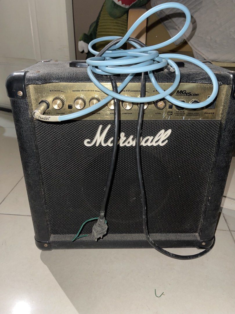 Marshall MG15CDR Guitar Amplifier with Fender Cable (Category: Soundbars, Speakers & Amplifiers) located in Mandaluyong City. Submitted by lluisl (Listing ID 1465459642, Image 1). Description: - Brand/Model: Marshall MG15CDR Guitar Amp (45 Watts) - Condition: Working, powers up fine (dusty from storage, needs a quick wipe down) - Features: Clean and overdrive channels, built-in reverb, headphone jack, and line out - Includes: Attached standard po
