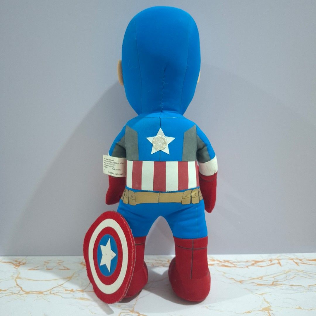 Marvel Captain America Plush Toy with Shield (Category: Plushies & Soft Toys) located in Baguio. Submitted by marjshane11317 (Listing ID 1465528167, Image 3). Description: - Official Marvel merchandise with original tag attached - Features iconic blue suit with red boots and gloves - Includes a removable shield that attaches to the back - Great addition for Avengers fans and toy collectors - Condition: Brand new / Excellent.