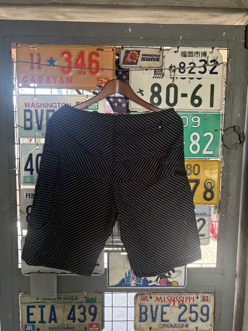 Matix Black White Striped Board Shorts Men (Category: Swim Trunks & Board Shorts) located in Tuguegarao City. Submitted by urdailyhabitat (Listing ID 1465424784, Image 2). Description: - Brand: Matix - Color: Black with white diagonal stripes - Waist: Adjustable drawstring closure with unique patterned drawstrings - Pockets: Includes a secure back zippered pocket - Details: Metal grommets and subtle branding tags on pocket and waistband - Materia