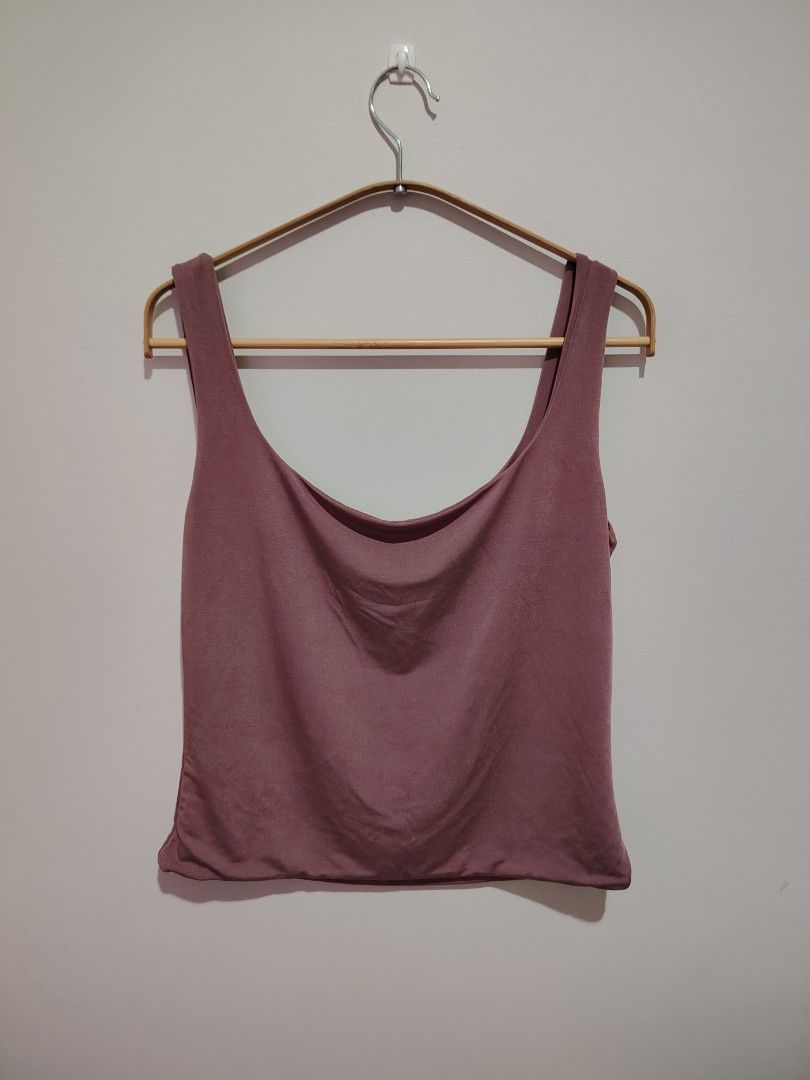 Mauve Top (Category: Sleeveless) located in Mandaluyong City. Submitted by declutter_kween (Listing ID 1465526883, Image 1). Description: - Color: Mauve - Style: Sleeveless tank top with deep scoop neckline and drape front - Material: Soft stretch fabric for all-day comfort - Versatility: Pairs easily with high-waisted jeans or skirts - Condition: Clean and well-maintained - Size is L but should fit M well.