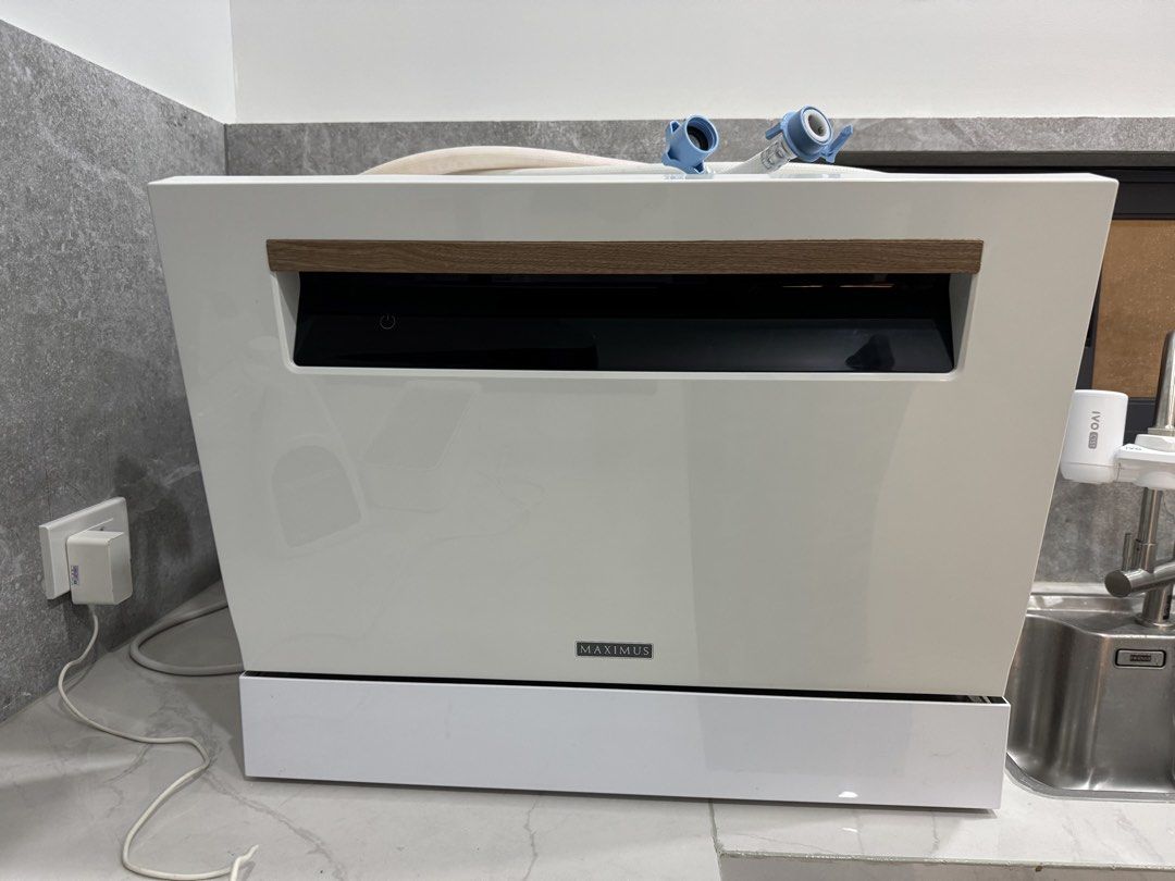 Maximus table top dishwasher (Category: Dishwasher) located in Paranaque City. Submitted by abigaylerocks (Listing ID 1465518280, Image 1). Description: Color: White (with wood handle) 6 place settings (European standard) 6 dinner plates, 6 soup plates, 6 dessert plates, 6 glasses, 6 tea cups, 6 saucers, 6 forks, 6 soup spoons, 6 dessert spoons, 6 teaspoons, 6 knives, 1 oval platter, 1 serving spoon, 1 gravy ladle, 1 serving fork Plug-and-play in