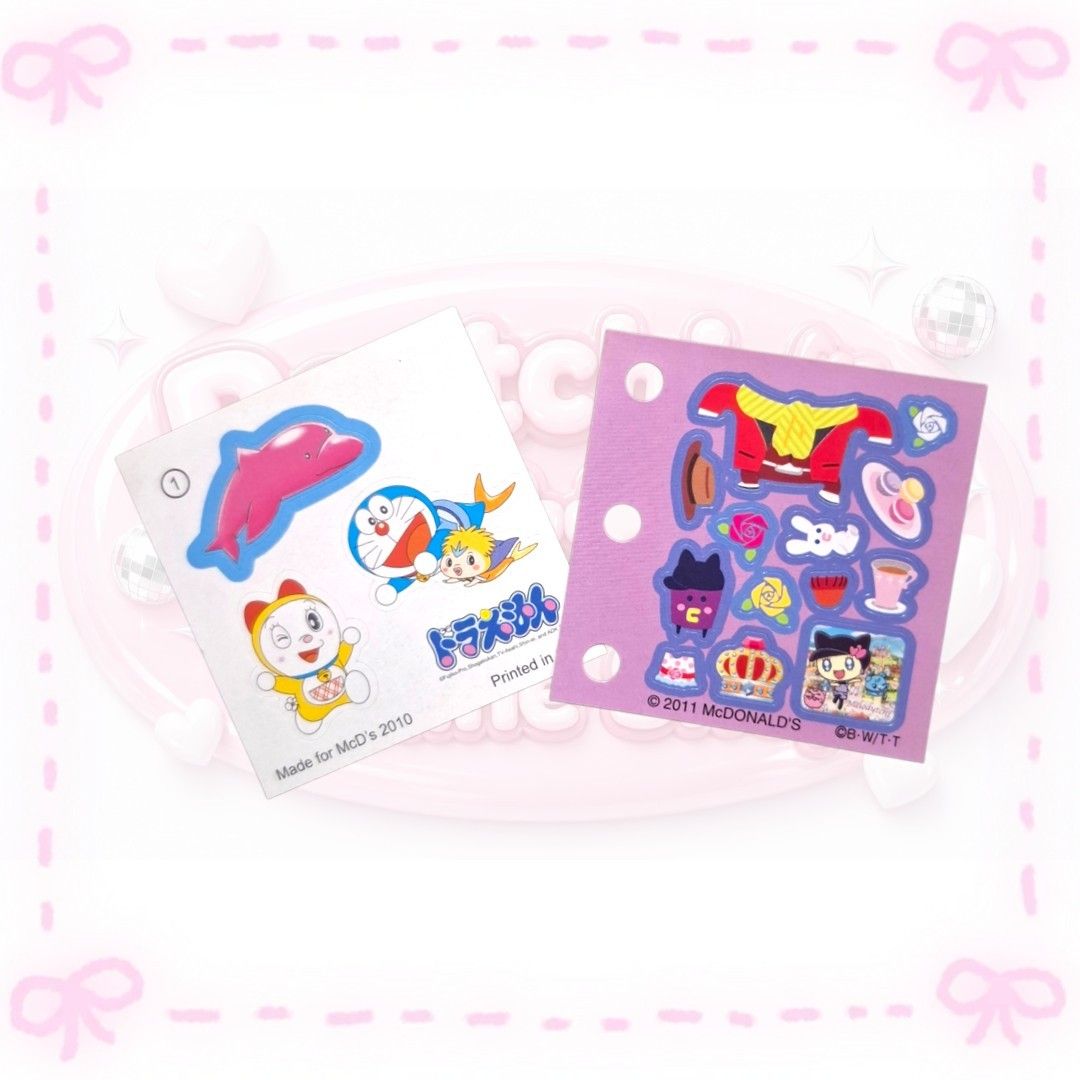 McDonald's Doraemon and Tamagotchi Sticker (Category: Character Goods) located in Sorsogon. Submitted by mitchelle0425 (Listing ID 1465531877, Image 1). Description: - Set of 2 vintage McDonald's promo sticker sheets (2010 & 2011) - Left sheet: Doraemon and friends with a pink dolphin (Dated 2010) - Right sheet: Tamagotchi character items and clothing with punch holes (Dated 2011) - Condition: Unused and adhesive is still fully intact - Rare find