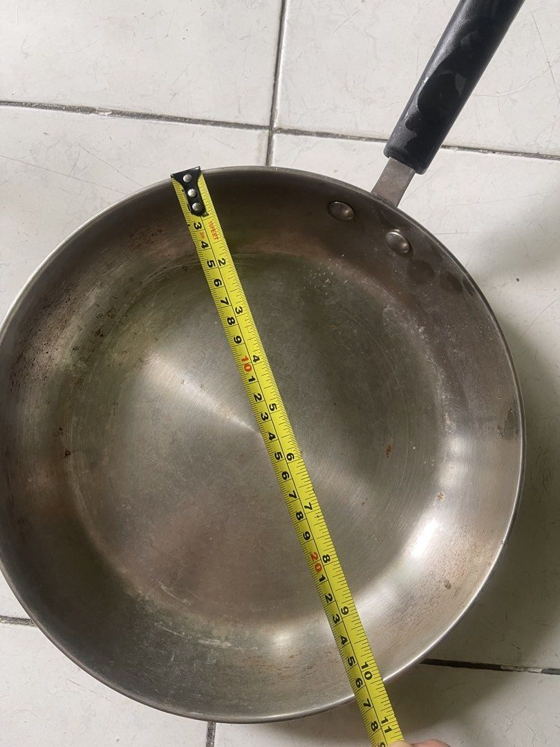 Meyer 26cm Stainless Steel Frying Pan (Category: Cookware & Accessories) located in Manila. Submitted by pasaybestfinds (Listing ID 1465412898, Image 3). Description: - Brand: Meyer - Size: 10-1/2 inches (26cm) across - Handle: Black handle secured with metal rivets - Base: Circular ridges on the bottom with embossed Meyer logo and compatibility icons - Surface: Stainless steel cooking surface with minor surface wear from previous use - Condition