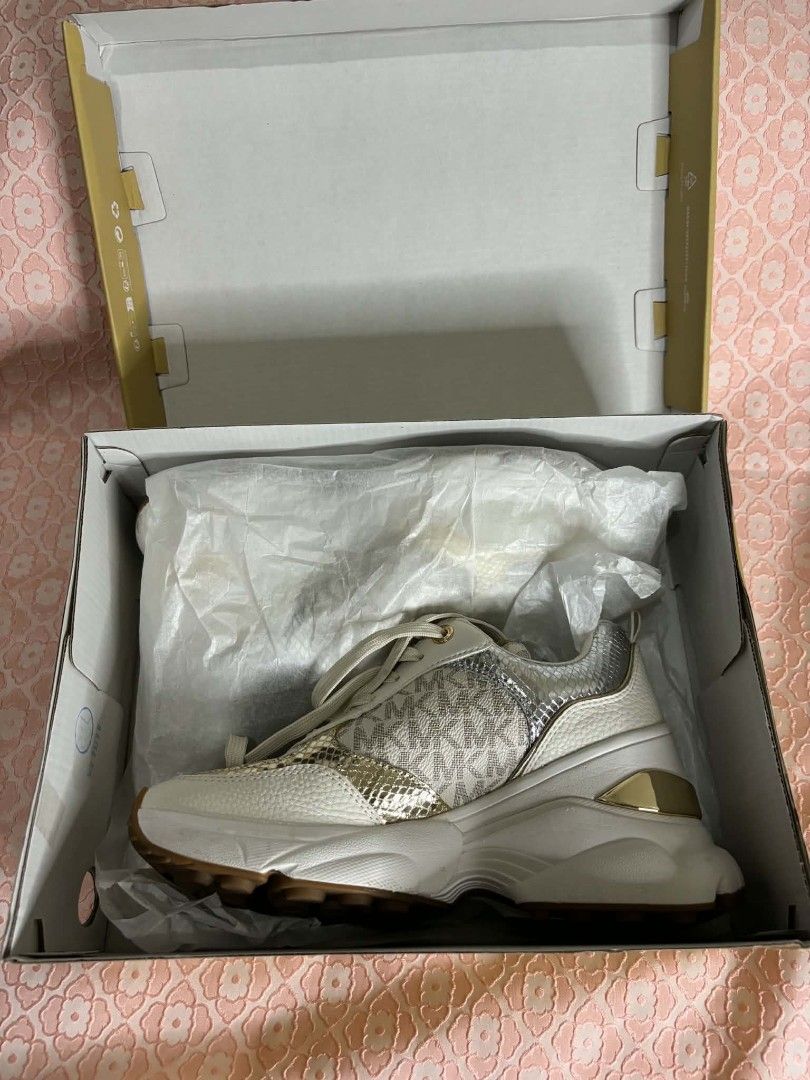 Michael Kors Katrina Wedge Trainer Vanilla Combo Size US 6M (Category: Sneakers) located in Bayombong. Submitted by rnstrifty (Listing ID 1465571272, Image 2). Description: - Brand: Michael Kors - Style: Katrina Wedge Trainers - Color/Print: Vanilla Combo (Signature MK monogram, gold & silver metallic snake print, white leather texture) - Size: US 6M - Features: Trendy chunky platform sole with rubber grip - Inclusion: Comes with original Michael