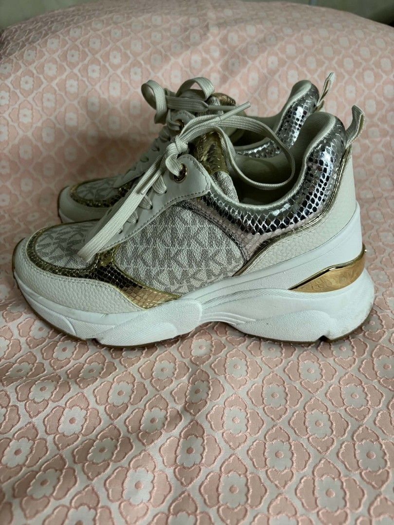 Michael Kors Katrina Wedge Trainer Vanilla Combo Size US 6M (Category: Sneakers) located in Bayombong. Submitted by rnstrifty (Listing ID 1465571272, Image 1). Description: - Brand: Michael Kors - Style: Katrina Wedge Trainers - Color/Print: Vanilla Combo (Signature MK monogram, gold & silver metallic snake print, white leather texture) - Size: US 6M - Features: Trendy chunky platform sole with rubber grip - Inclusion: Comes with original Michael