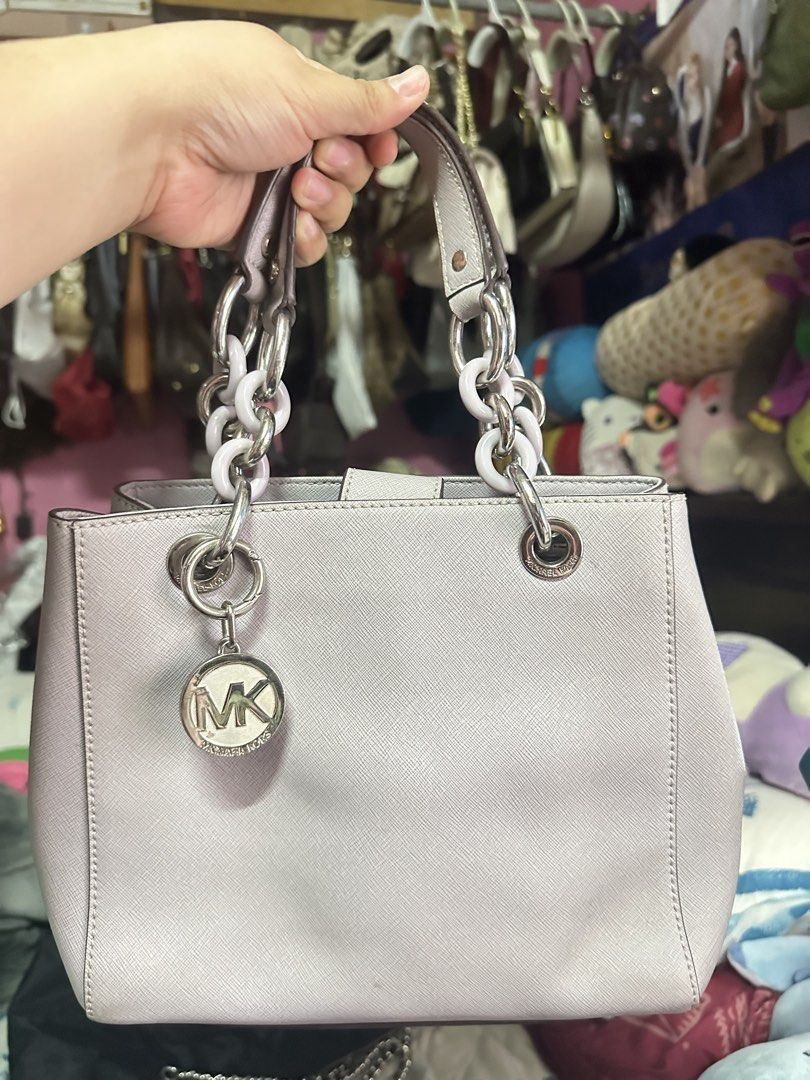 Michael Kors Medium Cynthia Satchel (Category: Luxury Bags & Wallets) located in Manila. Submitted by simarialigayako (Listing ID 1465559166, Image 1). Description: - Authentic Michael Kors tote bag in a gorgeous light purple shade - Crafted from durable Saffiano leather with sleek silver hardware - Includes signature hanging MK circle logo charm - Dual chain and leather handles plus an adjustable matching shoulder strap - Secure magnetic snap to