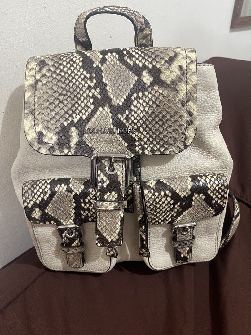 !!!RUSH!!!Michael Kors Python Print Leather Backpack (Category: Backpacks) located in Manila. Submitted by sunflowermama904 (Listing ID 1465444288, Image 1). Description: - Brand: Michael Kors - Material: Premium cream pebble leather with snakeskin print panels - Closure: Flap front with buckle and inner drawstring - Pockets: Two convenient exterior front pockets - Hardware: Silver-tone with branded interior lining - Extras: Includes original dus