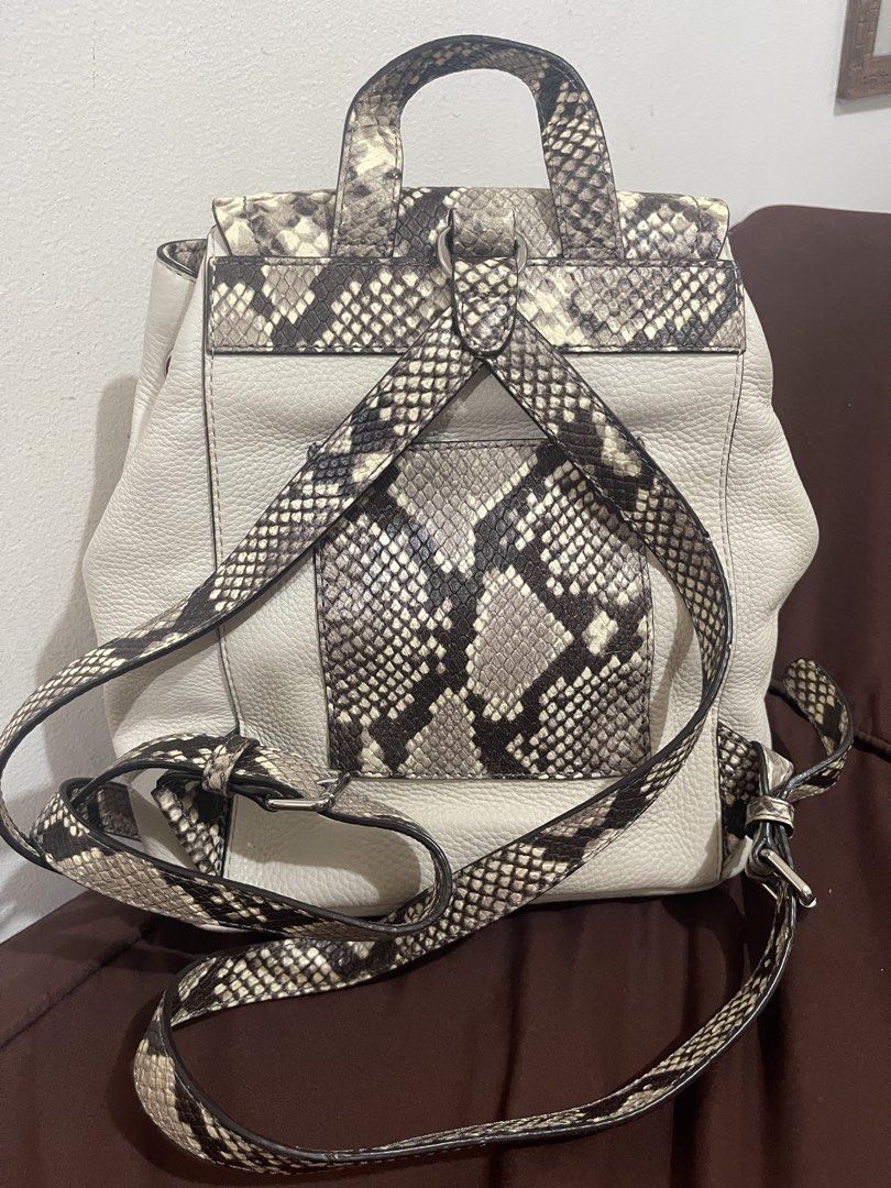 !!!RUSH!!!Michael Kors Python Print Leather Backpack (Category: Backpacks) located in Manila. Submitted by sunflowermama904 (Listing ID 1465444288, Image 2). Description: - Brand: Michael Kors - Material: Premium cream pebble leather with snakeskin print panels - Closure: Flap front with buckle and inner drawstring - Pockets: Two convenient exterior front pockets - Hardware: Silver-tone with branded interior lining - Extras: Includes original dus
