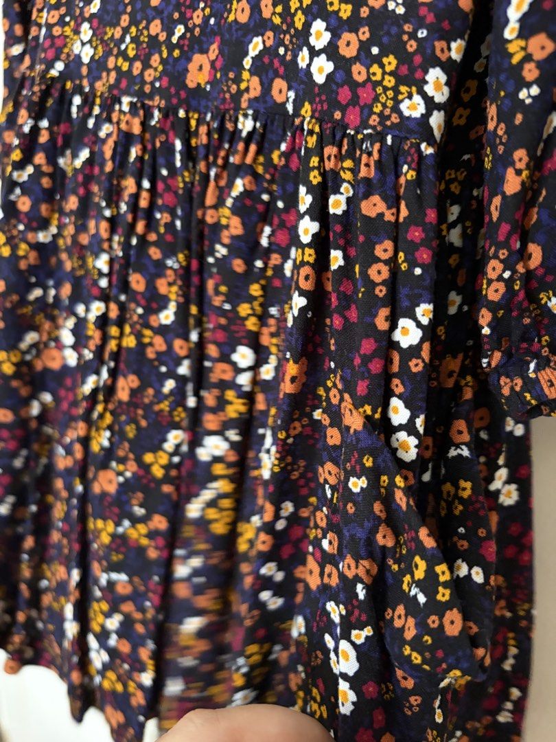 Mini Mango Floral Dress (Category: Babies & Kids Fashion) located in Paranaque City. Submitted by mayan_q (Listing ID 1465450845, Image 3). Description: - Brand: Mango - Size: 2 (Made in India) - Design: Black with vibrant orange, white, and yellow floral print - Features: 3/4 sleeves, gathered waist, cute tiered skirt, and 3 wooden buttons at the back neckline - Material: Lightweight and comfortable fabric - Condition: Excellent / Brand new-like