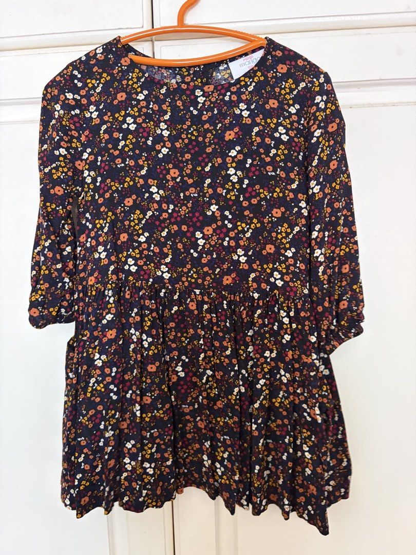 Mini Mango Floral Dress (Category: Babies & Kids Fashion) located in Paranaque City. Submitted by mayan_q (Listing ID 1465450845, Image 1). Description: - Brand: Mango - Size: 2 (Made in India) - Design: Black with vibrant orange, white, and yellow floral print - Features: 3/4 sleeves, gathered waist, cute tiered skirt, and 3 wooden buttons at the back neckline - Material: Lightweight and comfortable fabric - Condition: Excellent / Brand new-like