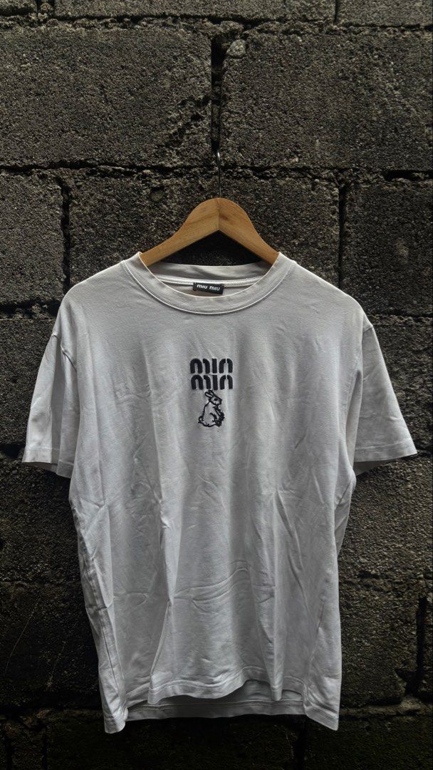MIU MIU X TOM & JERRY WHITE TEE (Category: Luxury Apparel) located in Quezon City. Submitted by erodinamict (Listing ID 1465437313, Image 2). Description: Size:L-XL Good Condition Color Rate: 9/10 Need Wash, Stains Dimes: 22x28.