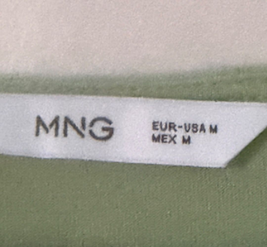V Neck Top from Mango (Category: Sleeveless) located in Santa Rosa. Submitted by biancamarie0404 (Listing ID 1465435592, Image 2). Description: - Brand: MNG (Mango) - Size: EUR/USA M, MEX M - Color: Green - Material: Smooth, satin-like fabric - Fit: Relaxed fit with a V-neck cut - Style: Versatile for casual wear or work attire - Condition: Excellent.
