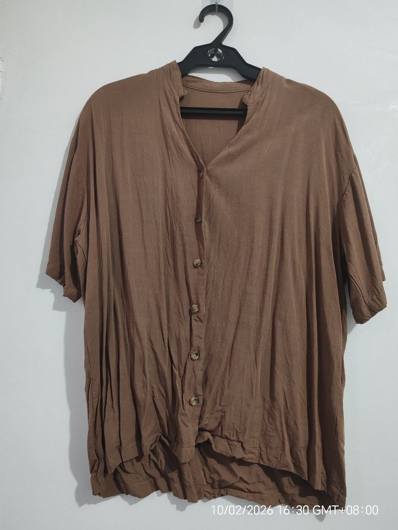 Mocha Oversized Button-Down Top | Loose Fit (Category: Blouses) located in Antipolo. Submitted by purpleclover11 (Listing ID 1465449609, Image 1). Description: Mocha oversized button-down top with a relaxed, flowy fit. Features a simple collarless/V-neck design, short sleeves, and button-down front. Lightweight and easy to pair with jeans, shorts, or trousers. • Brand: Unbranded • Color: Mocha / Brown • Fit: Oversized / Loose fit • Washed once • 