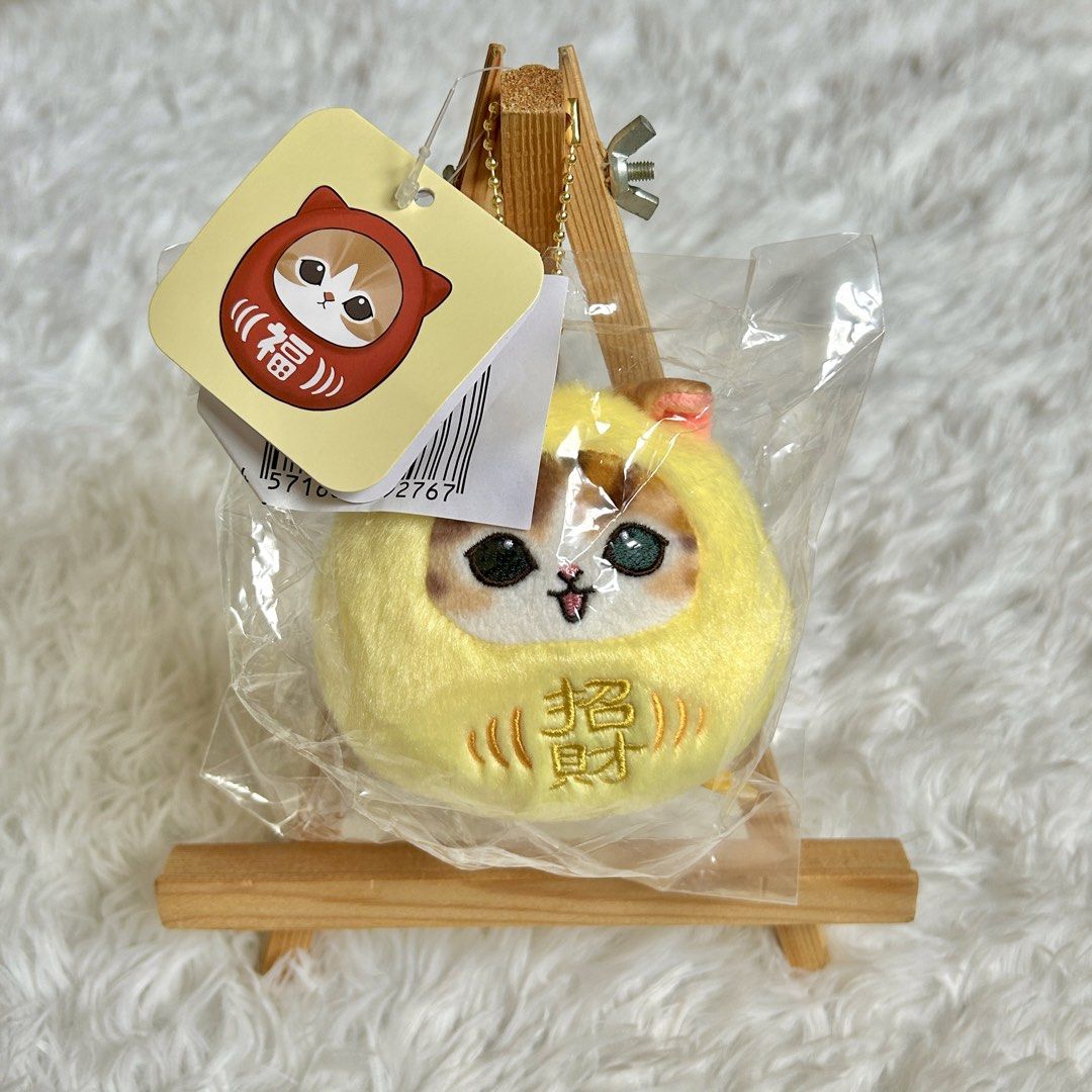 Mofusand Daruma Plush Keychain Lucky Charm (Category: Plushies & Soft Toys) located in Manila. Submitted by nekollection_ph (Listing ID 1465416517, Image 2). Description: - Authentic Japanese cat daruma plush keychain - Features cute kanji embroidery and a small, round soft toy design - Equipped with a gold bead chain for easy attachment to bags or keys - Brand new, sealed in original plastic packaging with paper tag intact - Available in 2 color