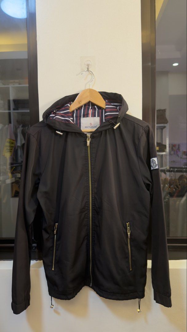 Moncler Hooded Zip Jacket Black Striped Lining (Category: Coats, Jackets and Outerwear) located in Paranaque City. Submitted by mykapoynton (Listing ID 1465548716, Image 2). Description: Moncler Hooded Zip Jacket Black Striped Lining - Color: Black with signature navy, red, and white striped lining - Hardware: Premium gold-tone with functional front zipper pockets - Features: Adjustable drawstring on both the hem and hood - Branding: Classic Monc