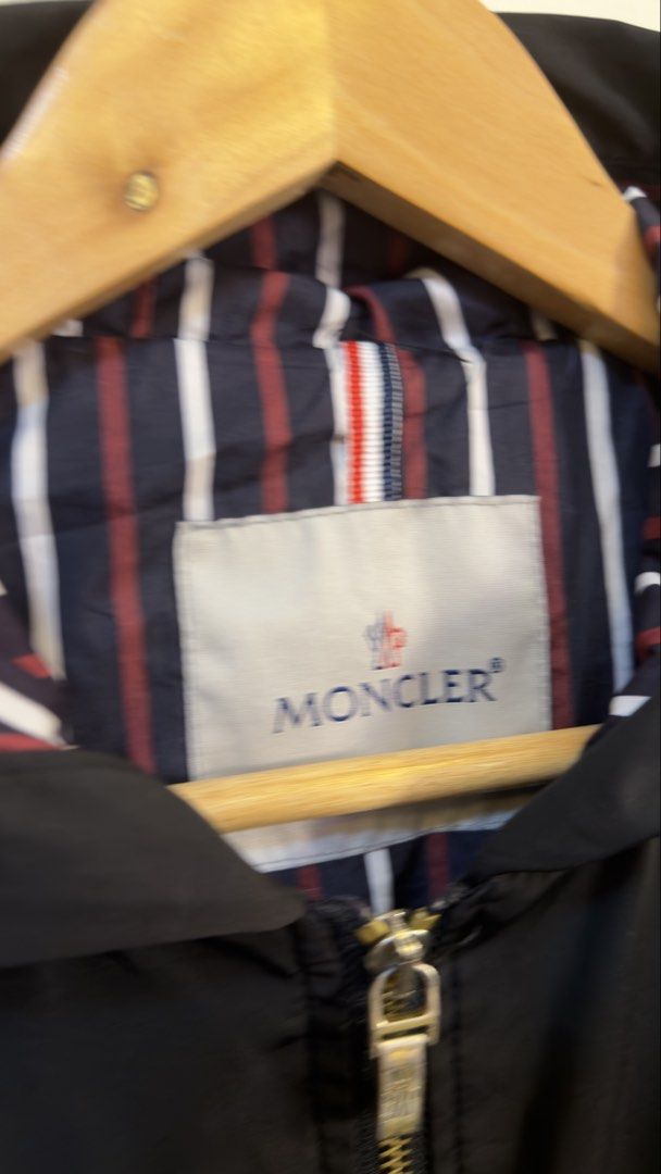 Moncler Hooded Zip Jacket Black Striped Lining (Category: Coats, Jackets and Outerwear) located in Paranaque City. Submitted by mykapoynton (Listing ID 1465548716, Image 3). Description: Moncler Hooded Zip Jacket Black Striped Lining - Color: Black with signature navy, red, and white striped lining - Hardware: Premium gold-tone with functional front zipper pockets - Features: Adjustable drawstring on both the hem and hood - Branding: Classic Monc