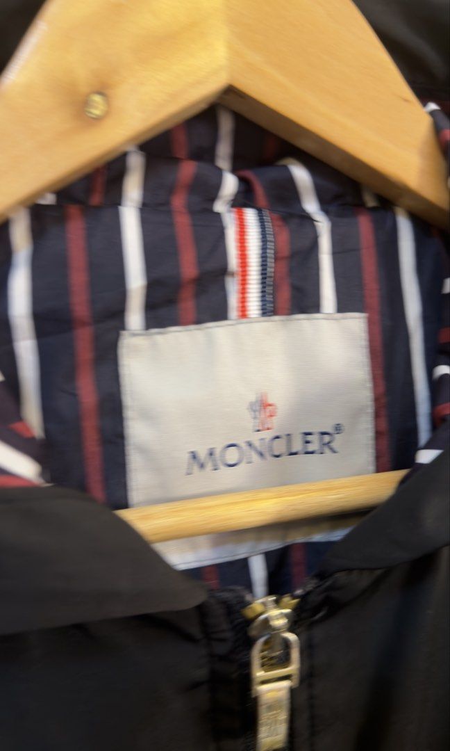 Moncler Hooded Zip Jacket Black Striped Lining (Category: Coats, Jackets and Outerwear) located in Paranaque City. Submitted by preluxeshop_ph (Listing ID 1465549357, Image 3). Description: Moncler Hooded Zip Jacket Black Striped Lining - Color: Black with signature navy, red, and white striped lining - Hardware: Premium gold-tone with functional front zipper pockets - Features: Adjustable drawstring on both the hem and hood - Branding: Classic M