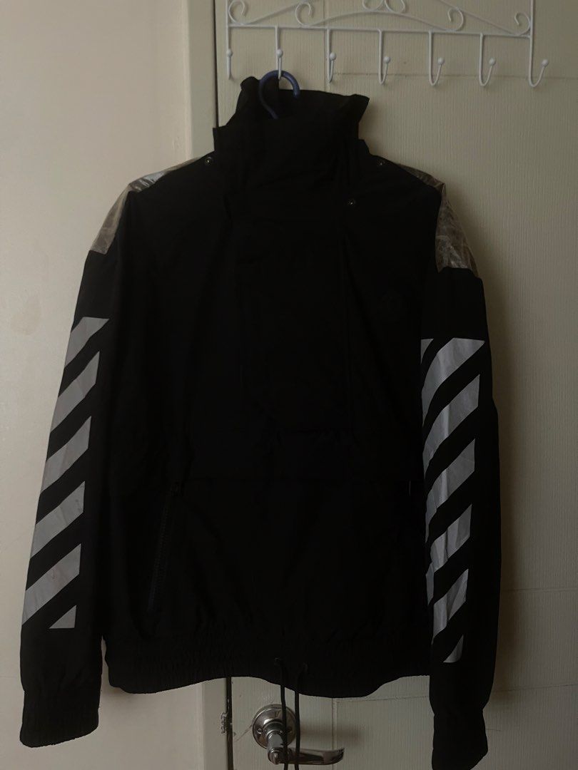 Moncler x Off-White Diagonal Logo Jacket (Category: Coats, Jackets and Outerwear) located in Santa Maria. Submitted by ernnarenez16859 (Listing ID 1465419654, Image 2). Description: - Brand: Moncler x Off-White - Color: Black - Material: 100% polyurethane - Design: Signature diagonal sleeve stripes and large back arrows graphic with transparent upper back panel - Features: Full zip front, hood, adjustable hem drawstrings, and side pockets - Authe