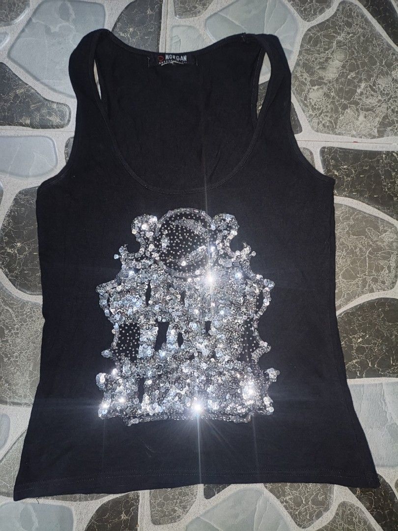 Morgan de Toi Black Tank Top with Silver Sequins (Category: Sleeveless) located in Narvacan. Submitted by picky_looter (Listing ID 1465525984, Image 1). Description: - Brand/Style: Authentic Morgan de Toi black tank top with a standard fit - Design: Eye-catching large silver sequin graphic with sparkling details - Comfort: Made from a soft, breathable cotton blend fabric - Details: Classic scoop neckline with supportive thick straps - Versatility