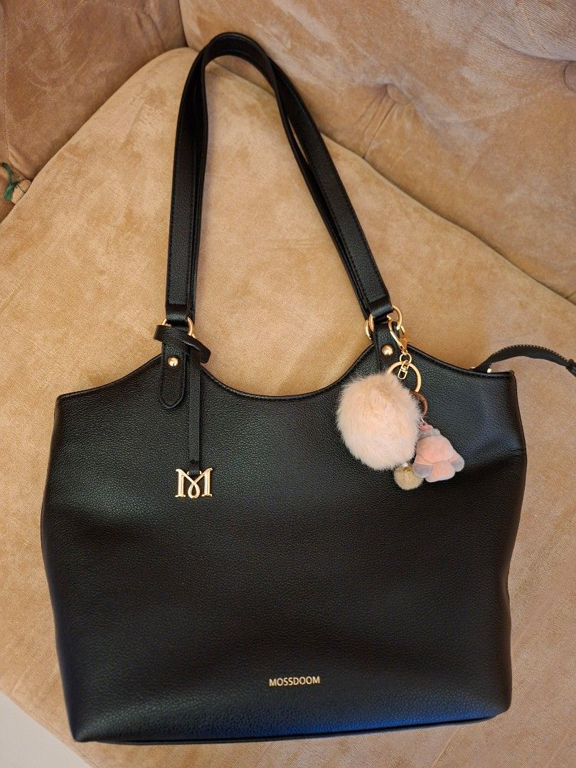 Mossdoom Lona Black Shoulder Bag (Category: Shoulder Bags) located in Quezon City. Submitted by vigie977 (Listing ID 1465428141, Image 2). Description: - Brand: Mossdoom - Color: Black with gold-tone hardware - Material: Textured synthetic leather - Closure: Top zipper - Features: Dual shoulder straps, front gold logo lettering, and 'M' metal emblem .