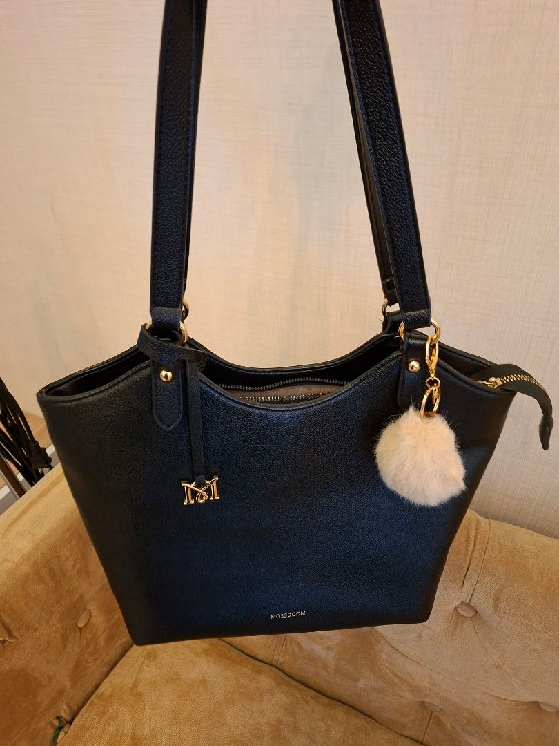 Mossdoom Lona Black Shoulder Bag (Category: Shoulder Bags) located in Quezon City. Submitted by vigie977 (Listing ID 1465428141, Image 1). Description: - Brand: Mossdoom - Color: Black with gold-tone hardware - Material: Textured synthetic leather - Closure: Top zipper - Features: Dual shoulder straps, front gold logo lettering, and 'M' metal emblem .