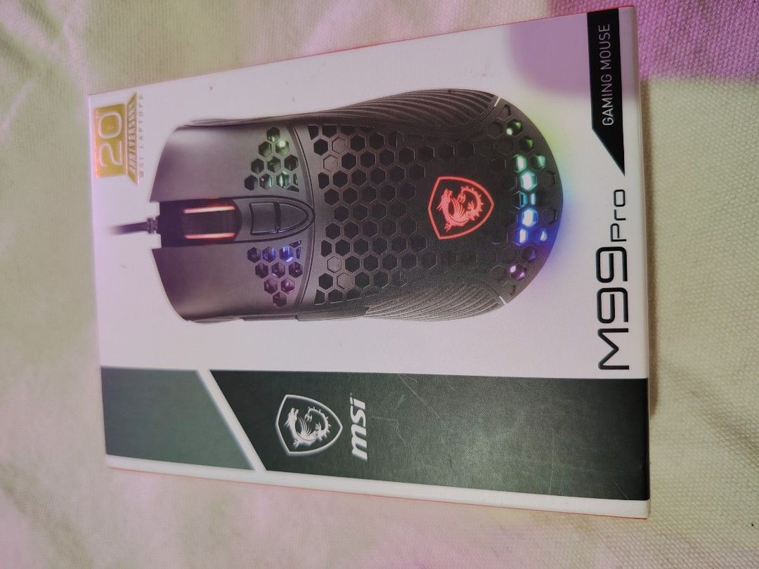 MSI M99 Pro Gaming Mouse (Category: Mouse & Mousepads) located in Mandaluyong City. Submitted by declutter_kween (Listing ID 1465525999, Image 3). Description: - Model: MSI M99 Pro Gaming Mouse (Black) - Lightweight honeycomb shell design - Durable braided USB cable with attached neatness strap - Includes original box and instruction manual - Fully tested 100% working - Never used, comes with own box.
