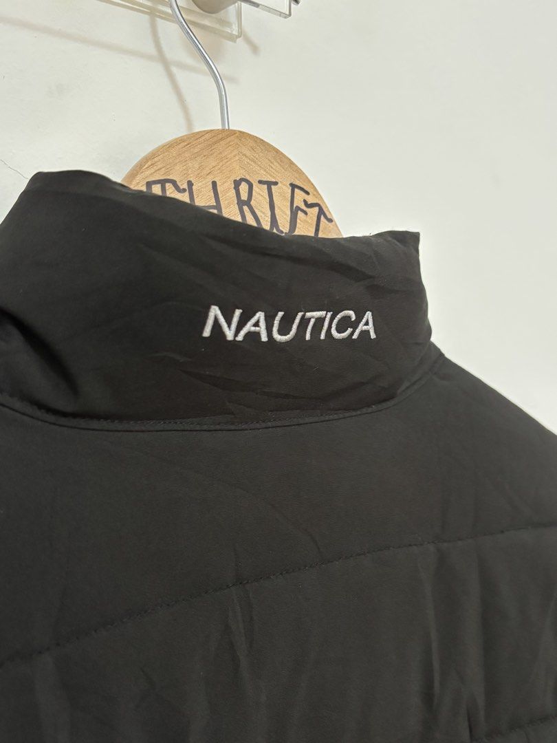 Nautica Black Puffer Jacket Size M (Category: Coats, Jackets and Outerwear) located in Silang. Submitted by lakasthrift1577 (Listing ID 1465417952, Image 3). Description: Nautica puffer jacket in solid black, size M. Stand collar with embroidered Nautica branding on the back. Full zip closure with custom branded zipper pulls. Includes zippered chest pocket and two lower zip pockets. Water resistant, active stretch, and wind resistant fabric. Made