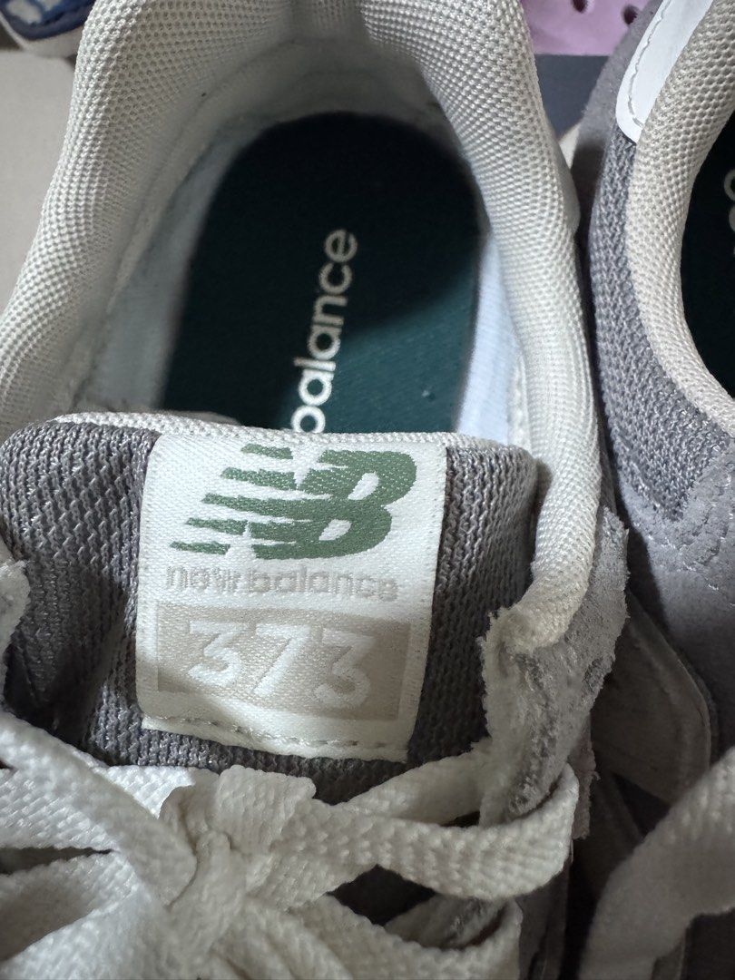 New Balance 373 Grey Sneakers (Category: Sneakers) located in Pasig City. Submitted by rowie_08 (Listing ID 1465517757, Image 2). Description: - Brand: New Balance 373 - Color: Grey with white, cream, and green accents - Materials: Classic suede and mesh upper with textured gum outsoles - Features: Signature N logo, white laces, and branded green tongue labels - Condition: Excellent everyday shoes with minimal wear on soles and uppers - Meetup or