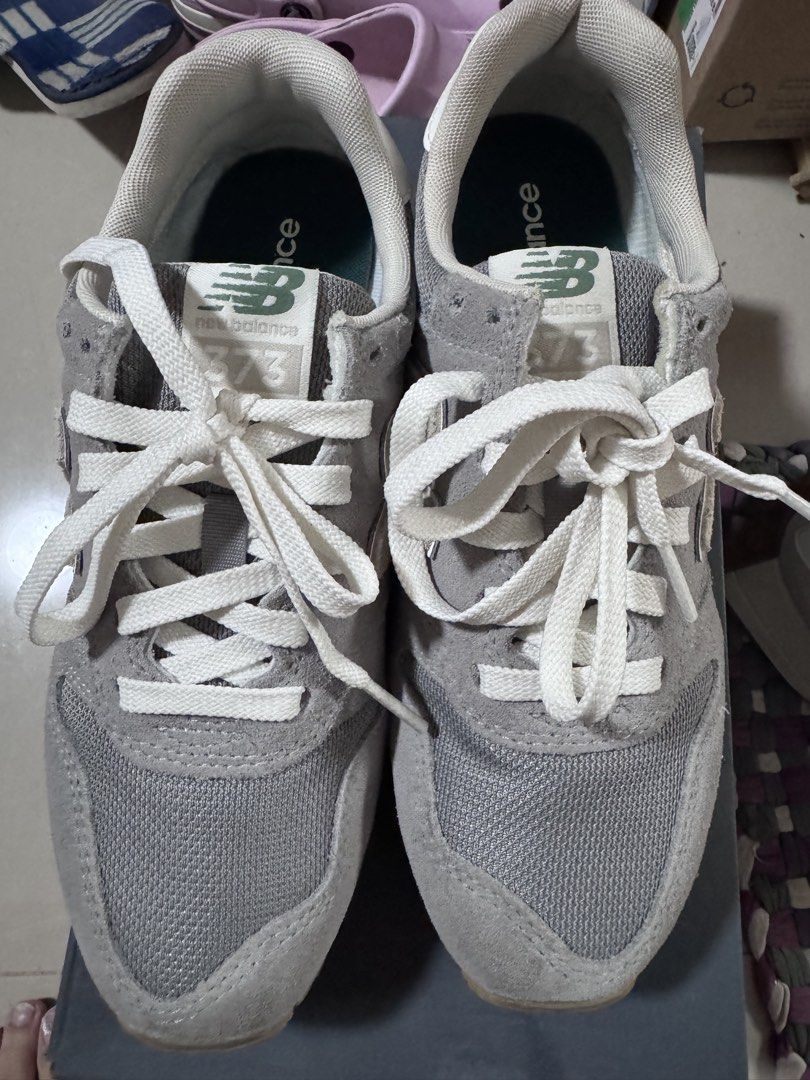 New Balance 373 Grey Sneakers (Category: Sneakers) located in Pasig City. Submitted by rowie_08 (Listing ID 1465517757, Image 1). Description: - Brand: New Balance 373 - Color: Grey with white, cream, and green accents - Materials: Classic suede and mesh upper with textured gum outsoles - Features: Signature N logo, white laces, and branded green tongue labels - Condition: Excellent everyday shoes with minimal wear on soles and uppers - Meetup or