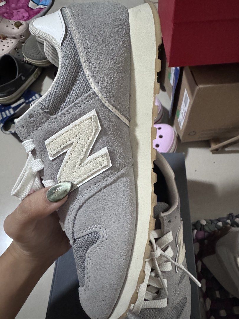 New Balance 373 Grey Sneakers (Category: Sneakers) located in Pasig City. Submitted by rowie_08 (Listing ID 1465517757, Image 3). Description: - Brand: New Balance 373 - Color: Grey with white, cream, and green accents - Materials: Classic suede and mesh upper with textured gum outsoles - Features: Signature N logo, white laces, and branded green tongue labels - Condition: Excellent everyday shoes with minimal wear on soles and uppers - Meetup or
