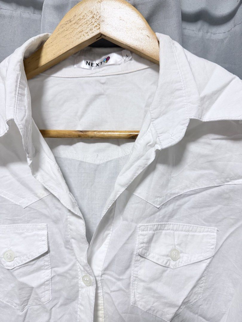 Next White Long Sleeve Button-Up Shirt (Category: Longsleeves) located in Manila. Submitted by saichyy (Listing ID 1465526469, Image 2). Description: - Brand: Next - Size: S - Color: White - Style: Long sleeve button-up with classic collar - Details: Dual front chest pockets with button flaps - Material: Lightweight and comfortable - Condition: Great for casual outings or workwear.