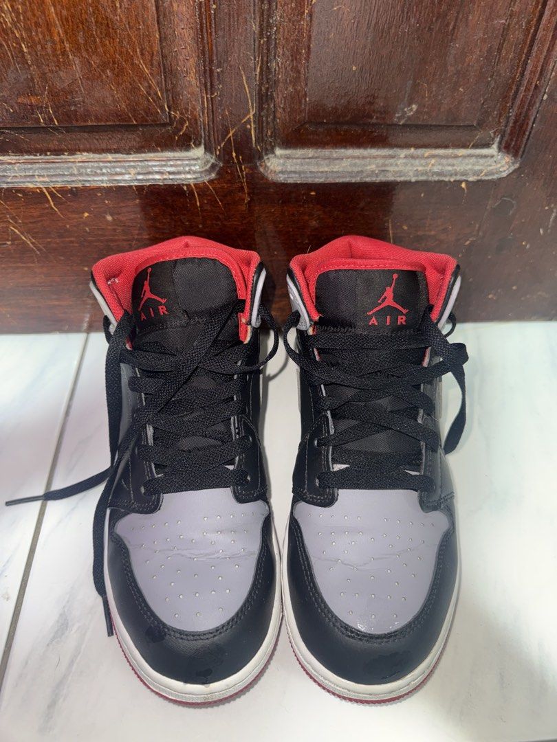 Nike Air Jordan 1 Mid Grey Black Red (Category: Sneakers) located in Quezon City. Submitted by tinemacasa99211 (Listing ID 1465541232, Image 1). Description: - Model: Jordan 1 Mid - Colourway: Grey, black, and red with red inner lining - Size: Youth 6Y / EUR 38.5 / US 7.5 WOMEN - Condition: Ready to wear with visible toe box creasing from normal use - Soles: Standard grip tread intact.