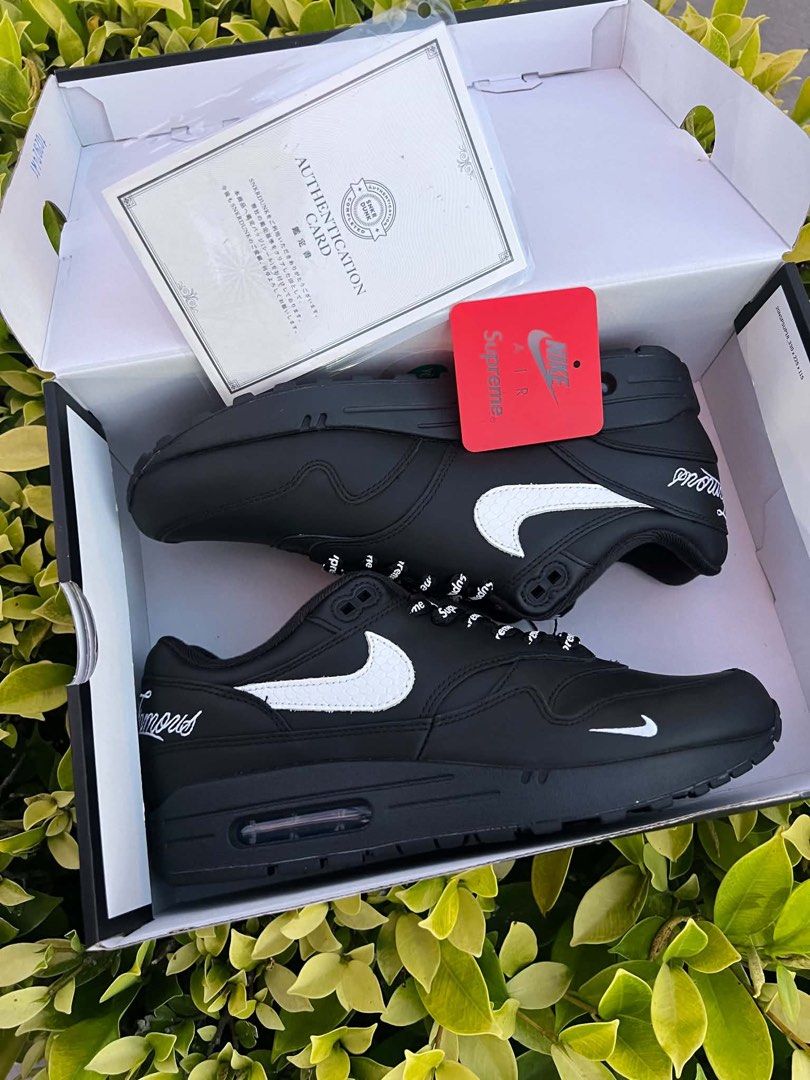 Nike Air Max 1 Supreme Black (Category: Sneakers) located in Bacolod City. Submitted by novymaesel14868 (Listing ID 1465423988, Image 2). Description: - Model: Nike Air Max 1 Supreme - Colorway: Black with white snakeskin swooshes - Details: Special branded repeating-logo laces and red insoles with Nike Air and Supreme branding - Condition/Inclusions: Complete with original box, authentication card, and SNKRDUNK tag - Guaranteed 100% authentic an