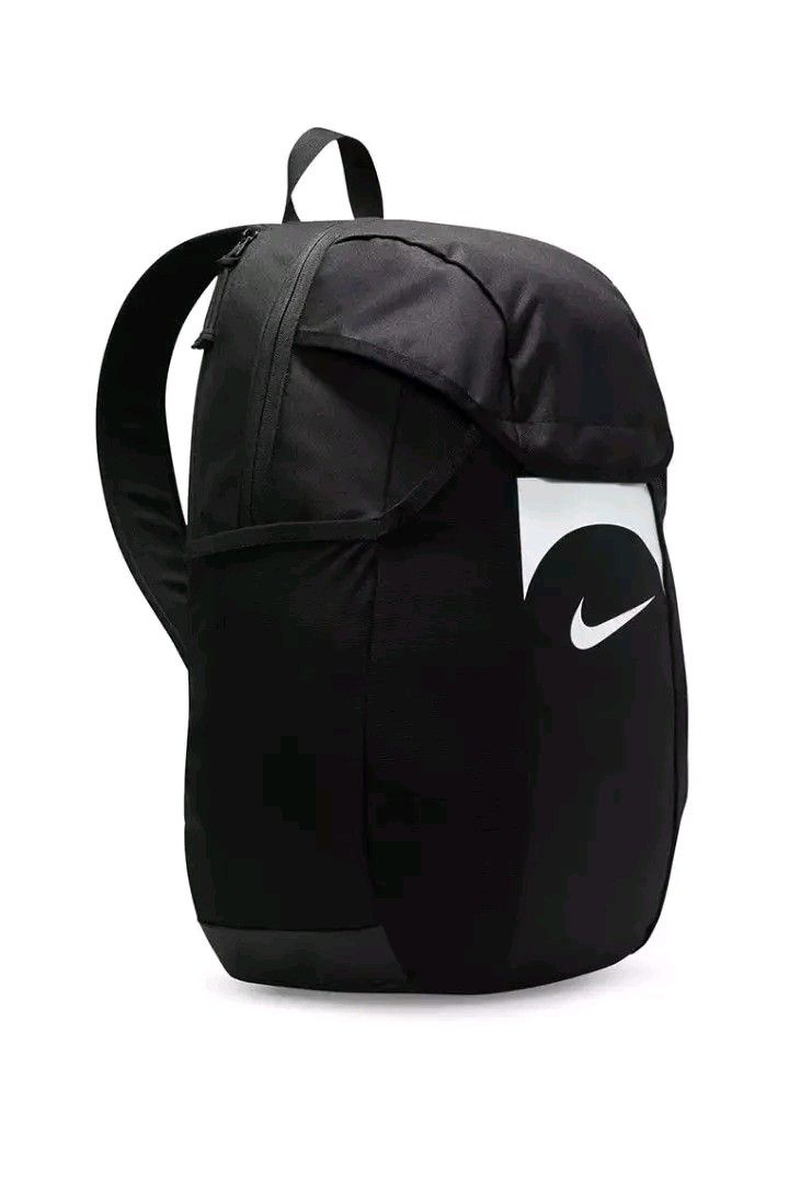 Nike Black Backpack with White Swoosh Logo (Category: Backpacks) located in Marikina City. Submitted by geloboixxx (Listing ID 1465465110, Image 2). Description: - Color: Sleek black with a striking white curved logo panel on the front - Storage: Spacious main compartment with top flap closure and a convenient side zipper pocket - Comfort & Portability: Sturdy, adjustable shoulder straps with a subtle Nike swoosh and a handy top handle - Material