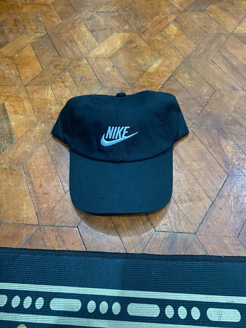 Nike Black Baseball Cap with Light Blue Logo (Category: Caps & Hats) located in Pasig City. Submitted by paulclzdo (Listing ID 1465455548, Image 1). Description: - Brand: Nike - Color: Classic black with light blue embroidery - Design: Iconic swoosh and Nike lettering on front, standard six-panel construction - Brim: Curved - Condition: Clean and ready to wear.
