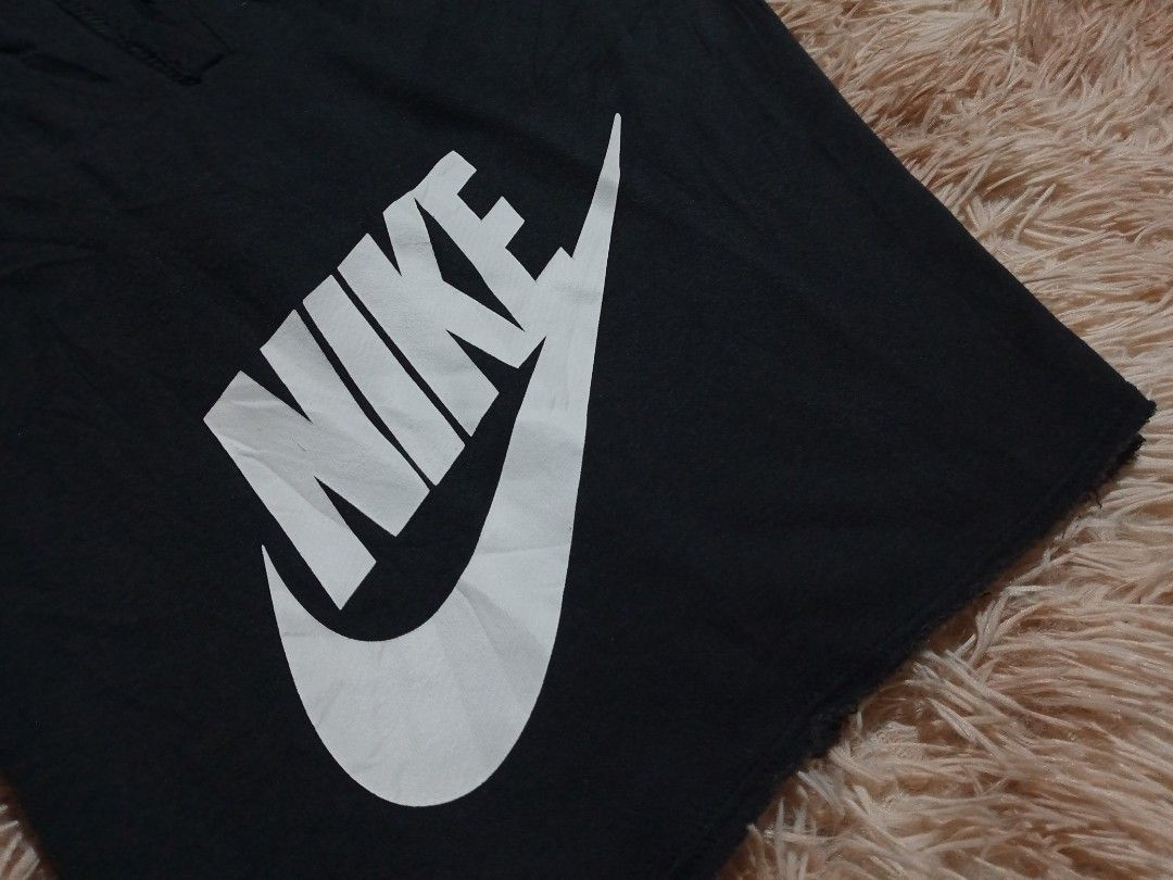 Nike Black Cotton Blend Shorts Size M (Category: Shorts) located in Boston. Submitted by johnpaulvi30029 (Listing ID 1465482919, Image 3). Description: - Brand: Nike - Item: Men's Shorts - Color: Black with white drawstrings and logo - Size: Medium - Design: Large vertical white Nike logo on left leg - Features: Two functional side pockets, adjustable drawstring waistband - Material: 53% cotton, 25% rayon, 17% polyester - Origin: Made in Thailand