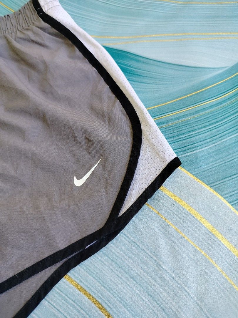 Nike Dri-Fit Grey Running Shorts Size M (Category: Shorts) located in Manila. Submitted by gerald_quinto (Listing ID 1465480334, Image 2). Description: - Brand: Nike -Size 24-30 - Style: Dri-Fit running shorts - Size: M - Color: Grey with white mesh side panels and black trim - Features: Elastic waistband with white drawstrings, interior care and product tags - Origin: Made in Vietnam.