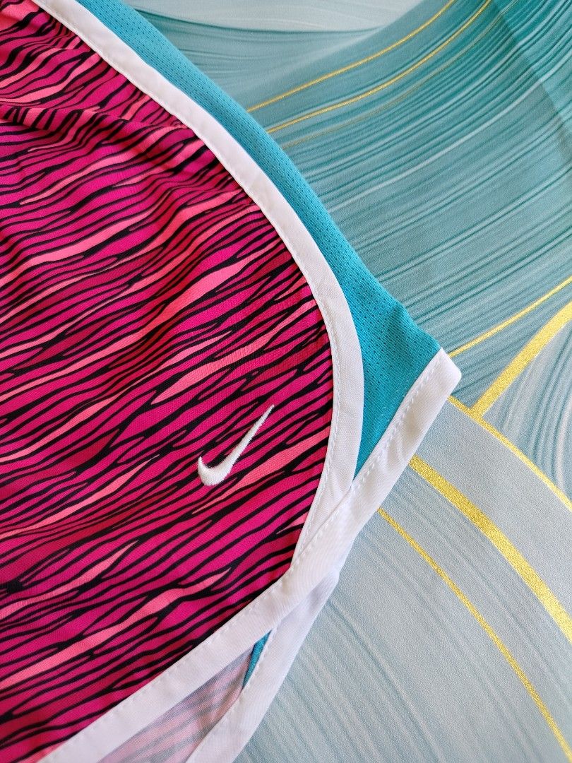 Nike Dri-FIT Pink Patterned Running Shorts Size XL (Category: Shorts) located in Manila. Submitted by gerald_quinto (Listing ID 1465480624, Image 2). Description: - Brand: Nike -Waist 28-36 - Style: Dri-FIT running shorts - Color/Pattern: Bright pink and black with turquoise mesh side panels and white piping trim - Features: Elastic waistband with inner black drawstring, Nike swoosh logo near left hem - Size: XL - Condition: Excellent (ready for 