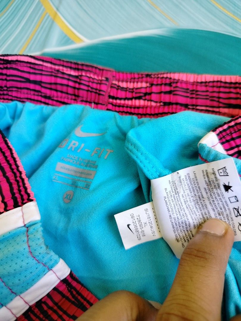 Nike Dri-FIT Pink Patterned Running Shorts Size XL (Category: Shorts) located in Manila. Submitted by gerald_quinto (Listing ID 1465480624, Image 3). Description: - Brand: Nike -Waist 28-36 - Style: Dri-FIT running shorts - Color/Pattern: Bright pink and black with turquoise mesh side panels and white piping trim - Features: Elastic waistband with inner black drawstring, Nike swoosh logo near left hem - Size: XL - Condition: Excellent (ready for 