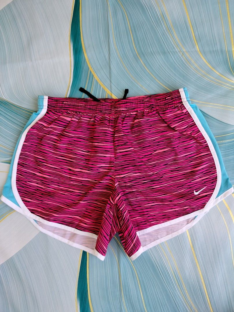Nike Dri-FIT Pink Patterned Running Shorts Size XL (Category: Shorts) located in Manila. Submitted by gerald_quinto (Listing ID 1465480624, Image 1). Description: - Brand: Nike -Waist 28-36 - Style: Dri-FIT running shorts - Color/Pattern: Bright pink and black with turquoise mesh side panels and white piping trim - Features: Elastic waistband with inner black drawstring, Nike swoosh logo near left hem - Size: XL - Condition: Excellent (ready for 