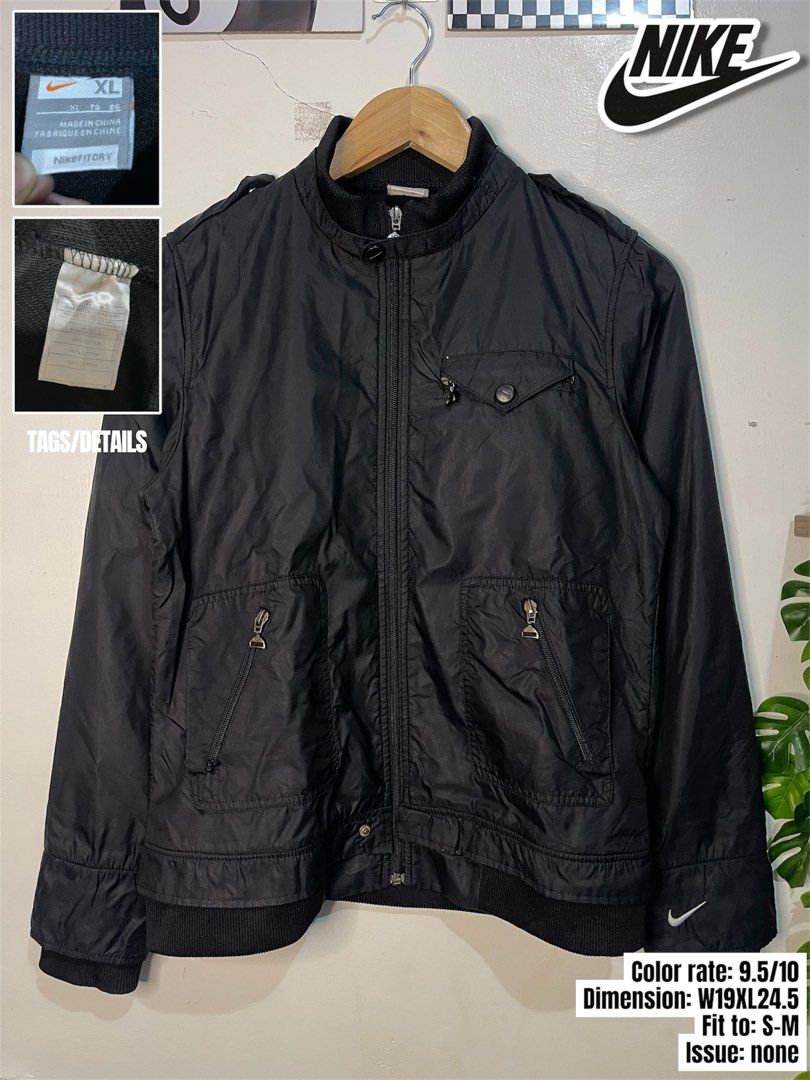 Nike Fitory Black Bomber Jacket XL (Category: Coats, Jackets and Outerwear) located in Cabagan. Submitted by blessingma81004 (Listing ID 1465430461, Image 1). Description: - Brand: Nike - Style: Bomber jacket - Color: Black - Size: XL - Origin: Made in China - Details: Front zip pockets, sleeve logo embroidery, ribbed collar, cuffs, and hem - Condition: Clean overall with solid zippers and buttons.