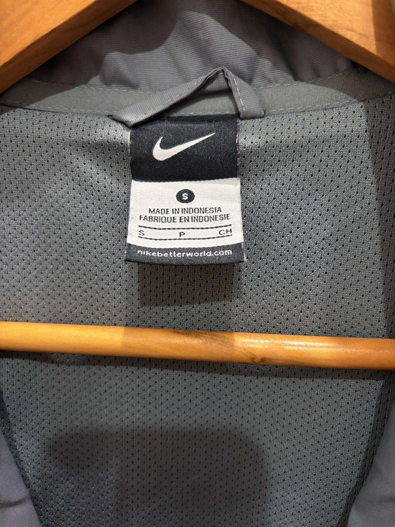 Nike Gray and Pink Windbreaker Jacket Size S (Category: Coats, Jackets and Outerwear) located in General Trias. Submitted by hayami.clo (Listing ID 1465386309, Image 3). Description: Gray Nike windbreaker with bright pink shoulder stripes and neon yellow swoosh logo on the chest. Full zip front with stand-up collar. Two zippered side pockets for secure storage. Lightweight mesh lining inside. Size S, made in Indonesia. 100% polyester material. Cl