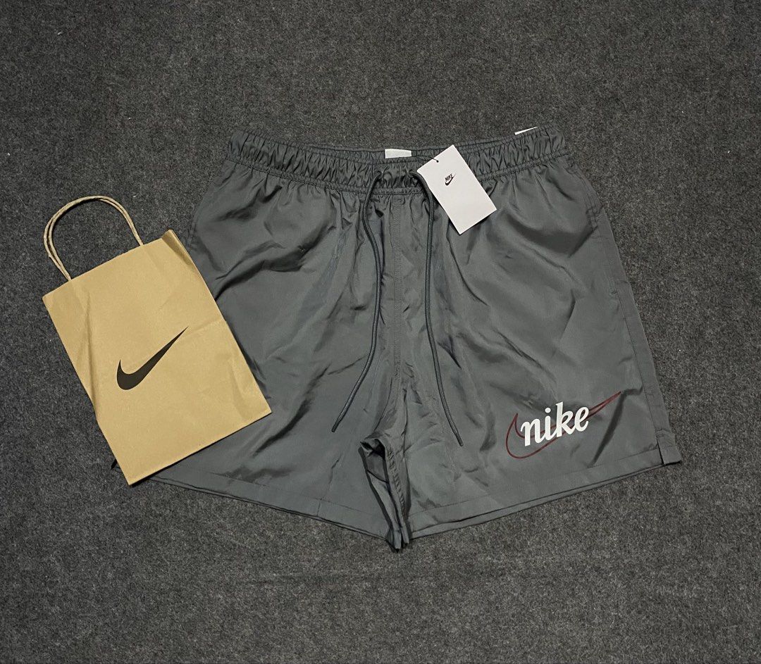 Nike Gray Shorts with Retro Script Logo Size XL (Category: Shorts) located in Cebu City. Submitted by yazherizthrifting (Listing ID 1465456226, Image 1). Description: Brand New - Brand: Nike - Item: Shorts - Color: Gray - Size: XL (Waist: 15" across, Length: 18.5") - Material: Lightweight nylon with mesh interior lining - Features: Elastic waistband with adjustable drawstrings, retro cursive Nike logo near the hem - Condition: Brand new with orig