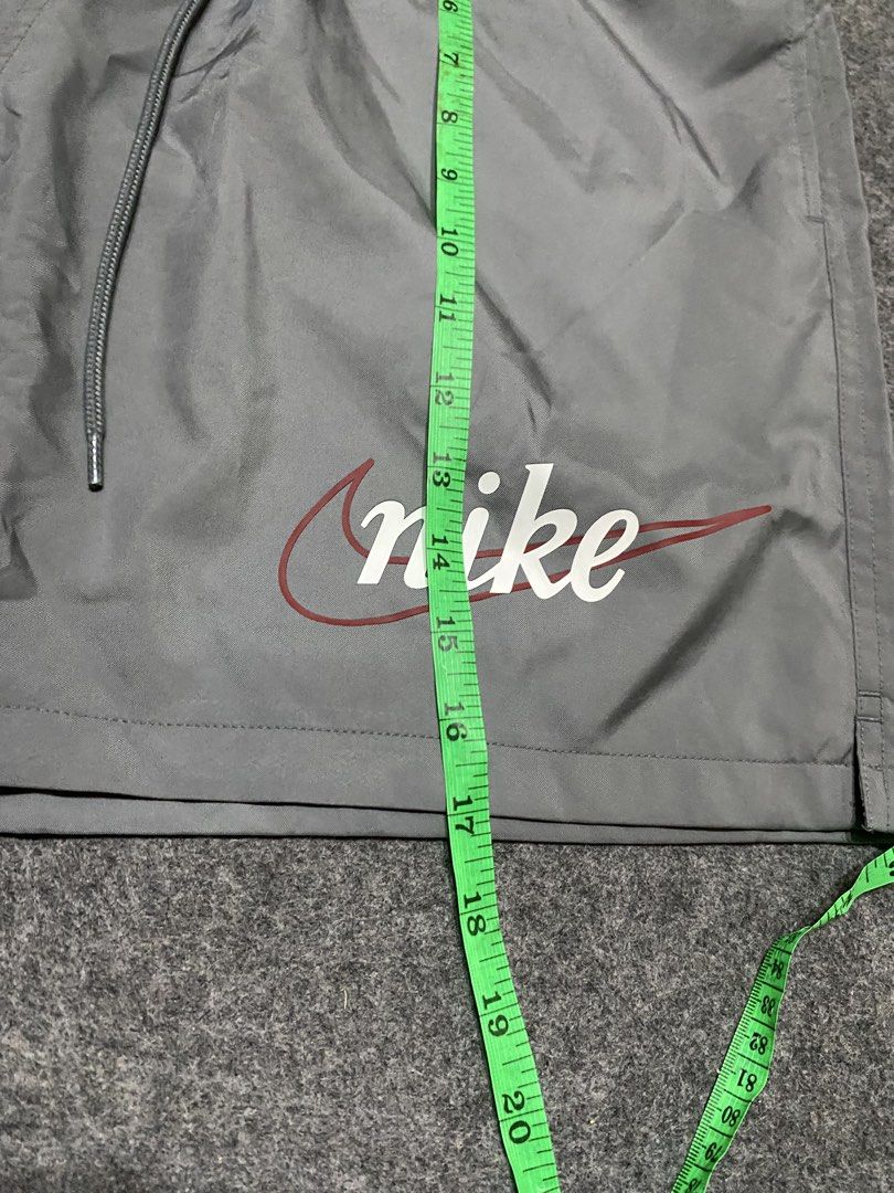 Nike Gray Shorts with Retro Script Logo Size XL (Category: Shorts) located in Cebu City. Submitted by yazherizthrifting (Listing ID 1465456226, Image 3). Description: Brand New - Brand: Nike - Item: Shorts - Color: Gray - Size: XL (Waist: 15" across, Length: 18.5") - Material: Lightweight nylon with mesh interior lining - Features: Elastic waistband with adjustable drawstrings, retro cursive Nike logo near the hem - Condition: Brand new with orig