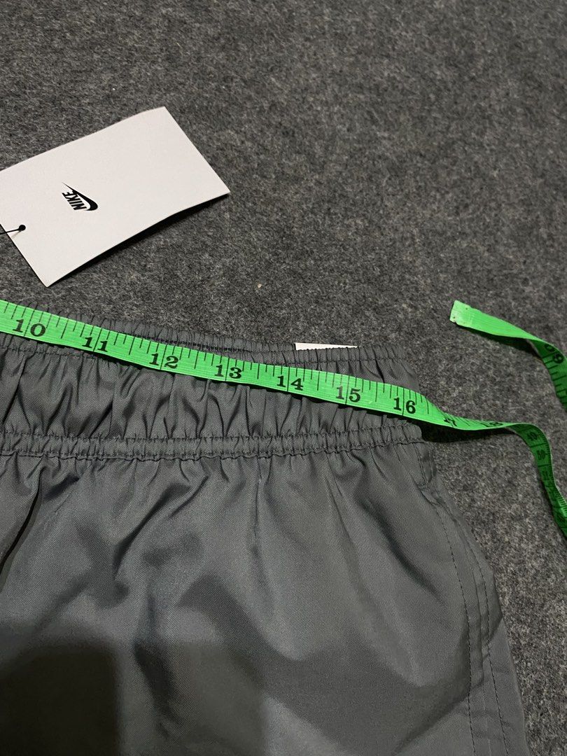 Nike Gray Shorts with Retro Script Logo Size XL (Category: Shorts) located in Cebu City. Submitted by yazherizthrifting (Listing ID 1465456226, Image 2). Description: Brand New - Brand: Nike - Item: Shorts - Color: Gray - Size: XL (Waist: 15" across, Length: 18.5") - Material: Lightweight nylon with mesh interior lining - Features: Elastic waistband with adjustable drawstrings, retro cursive Nike logo near the hem - Condition: Brand new with orig