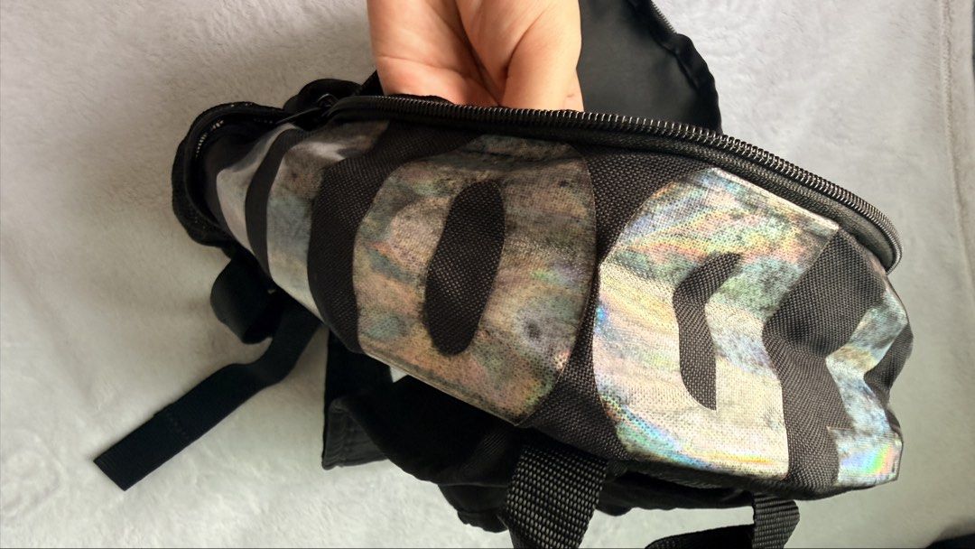 Nike Holographic Mini Backpack (Category: Backpacks) located in Quezon City. Submitted by shane_blueraee (Listing ID 1465402167, Image 3). Description: Nike mini backpack Color: Black with holographic top handle Pockets: Front zipped pocket with 'Just Do It' zipper tag, dual mesh side pockets Straps: Adjustable black shoulder straps - Condition: Pre-loved, faded holographic design (see pic) SF c/o buyer - delivery thru lalamove Meet up - SM North